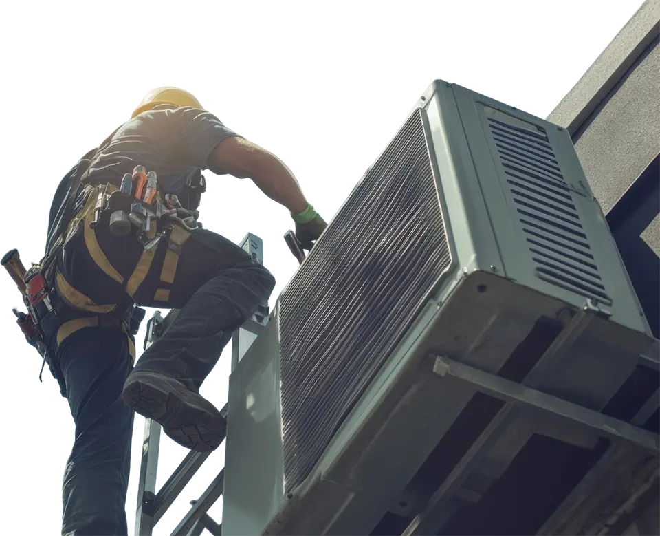 HVAC technician installing an AC unit on a rooftop.